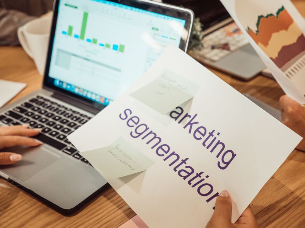 Crafting Captivating Headlines: Your awesome post title goes here A modern workspace showing hands analyzing marketing data on a laptop and paper documents.